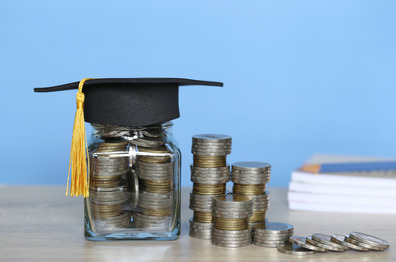 Coins in glasses with a doctoral hat